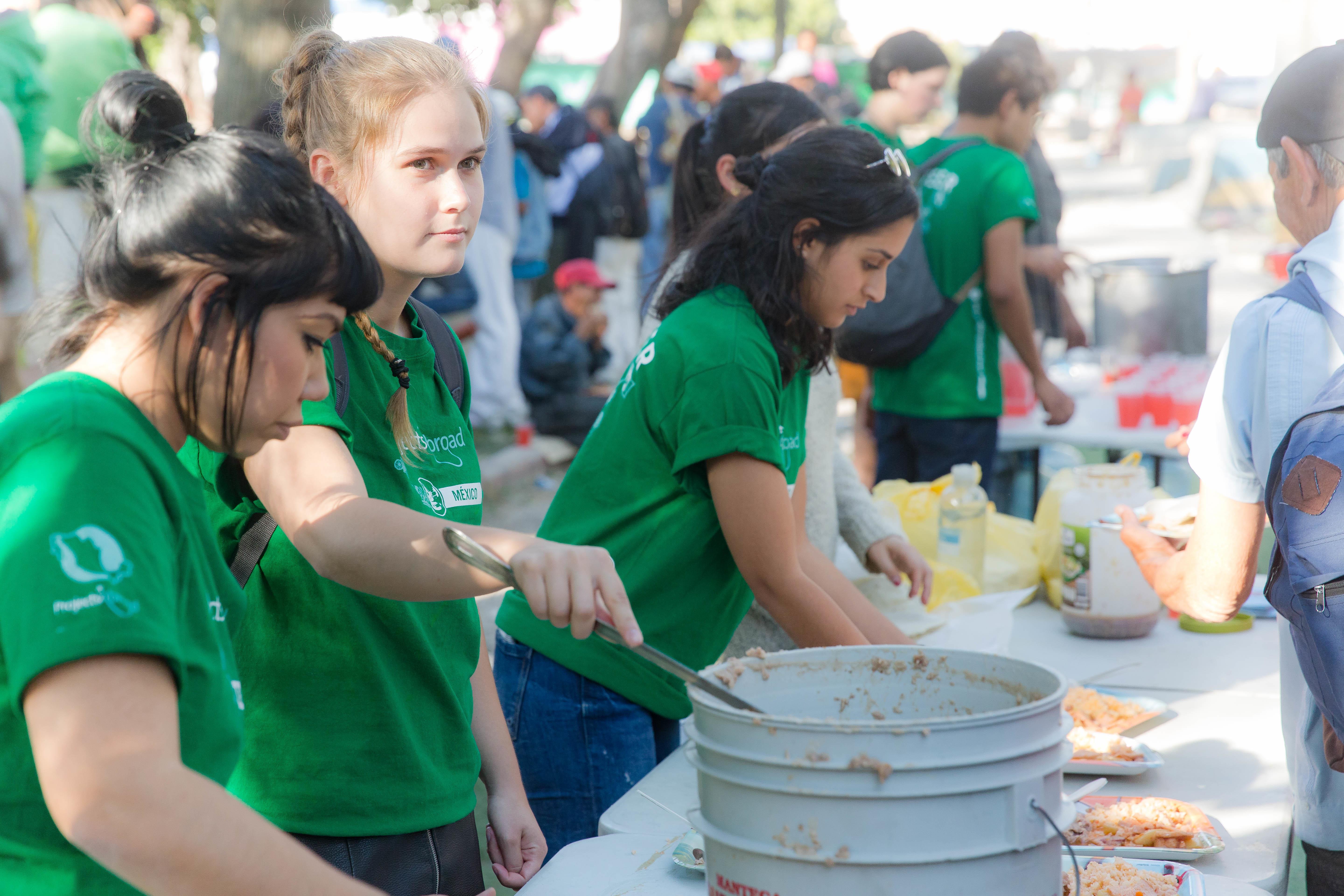 Projects Abroad International Development interns serve food at a shelter for immigrants during their International Development internships in Mexico. Female International Development Interns serve food at a shelter for immigrants at their work placement in Mexico.
